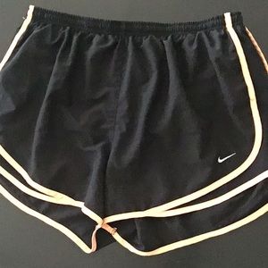 Orange and black nike running shorts